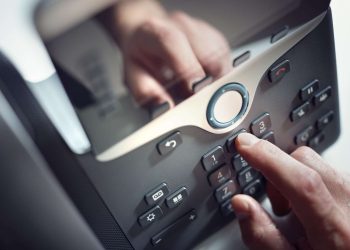 dialing-a-telephone-in-the-office-2021-08-26-22-29-56-utc min